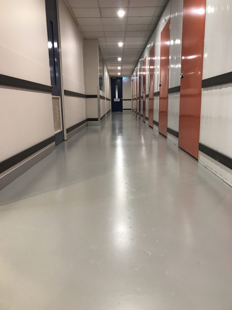 Grey epoxy floor in industrial storage warehouse